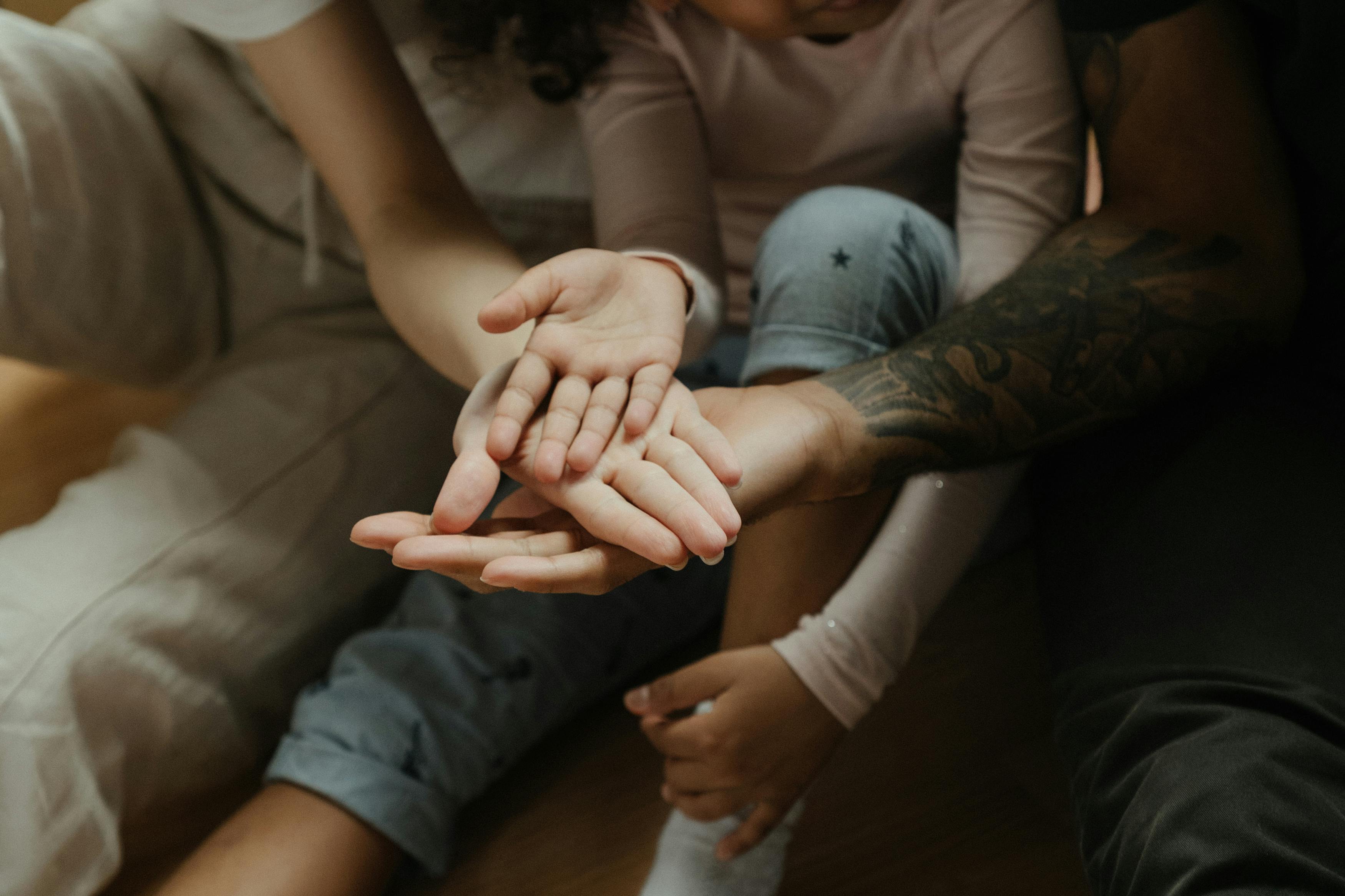 Man in Gray Shirt Holding Woman's Hand